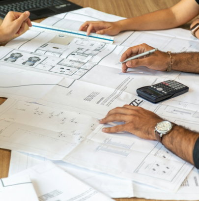 people-reviewing-architectural-blueprints-on-desk.jpg people reviewing architectural blueprints on desk